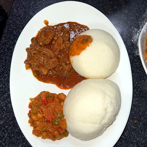 Beef stew with pap and chakalaka on a plate